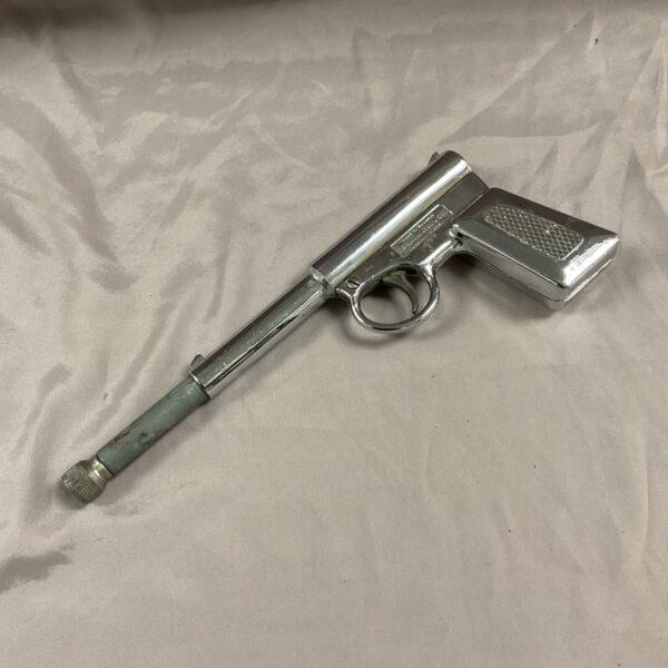 Vintage chrome gat gun toy pistol, side view.