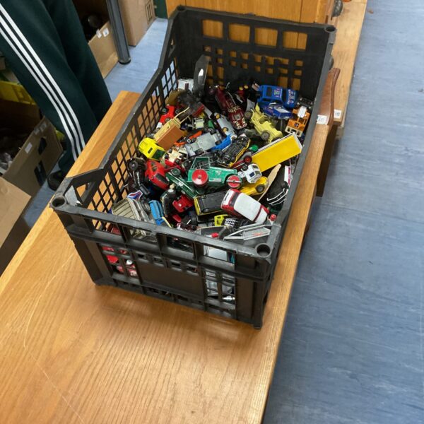 Crate filled with a large collection of vintage diecast toy cars.