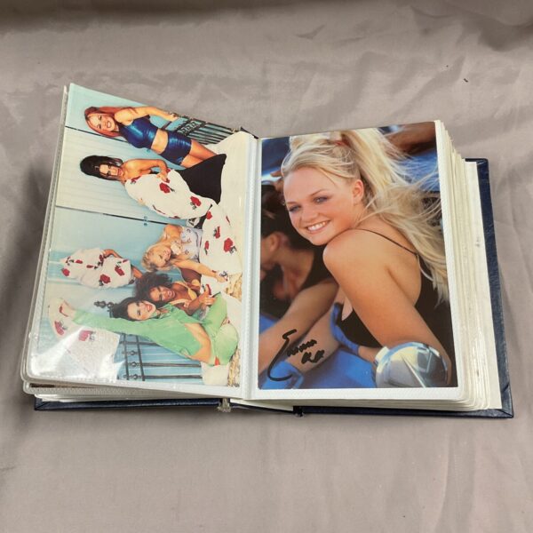 Spice Girls autograph book open to a page with group and individual photos.