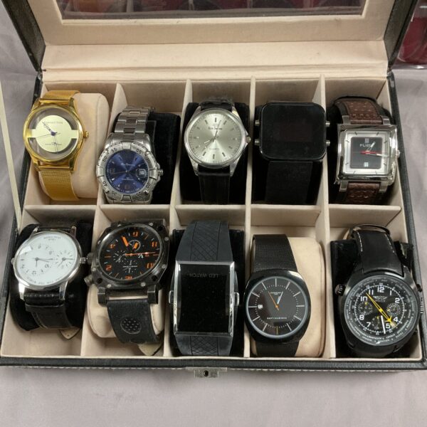 Vintage watch lot displayed in a case, assorted timepieces.