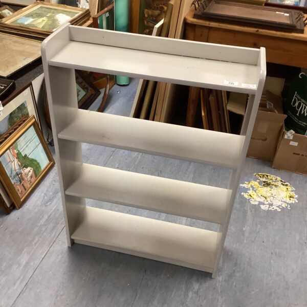 Vintage painted wooden book shelf for home storage and display.