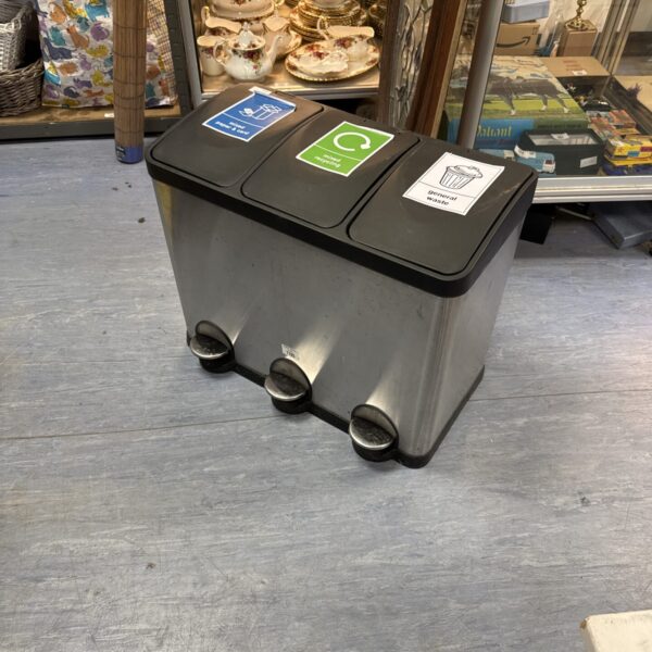 Stainless steel three-door recycling bin in a kitchen setting.