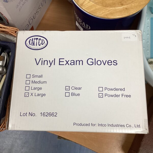 Sealed box of extra-large clear vinyl gloves for hygiene.