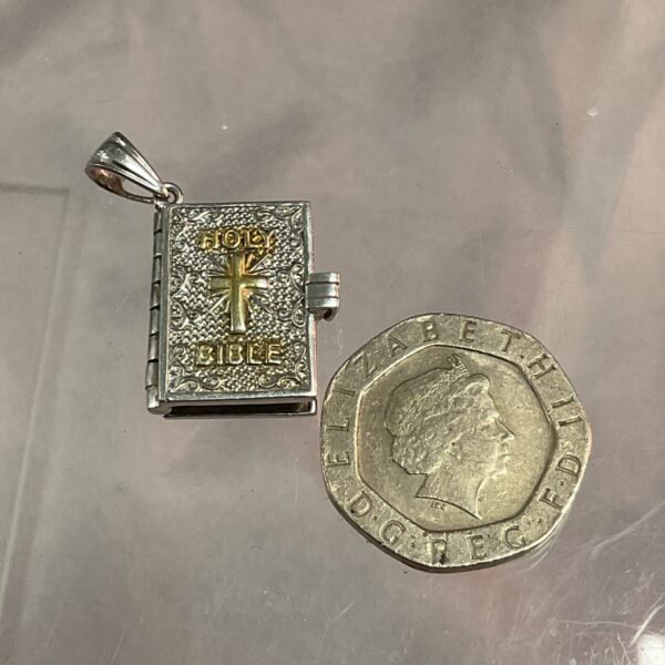 Detailed silver and gold Holy Bible pendant with cross.