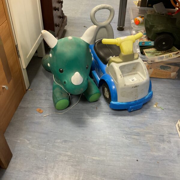 Vintage green dinosaur and blue ride on car toy.
