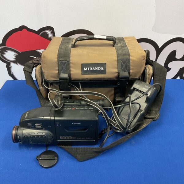 Vintage Canon E333 camcorder with cables for video recording.