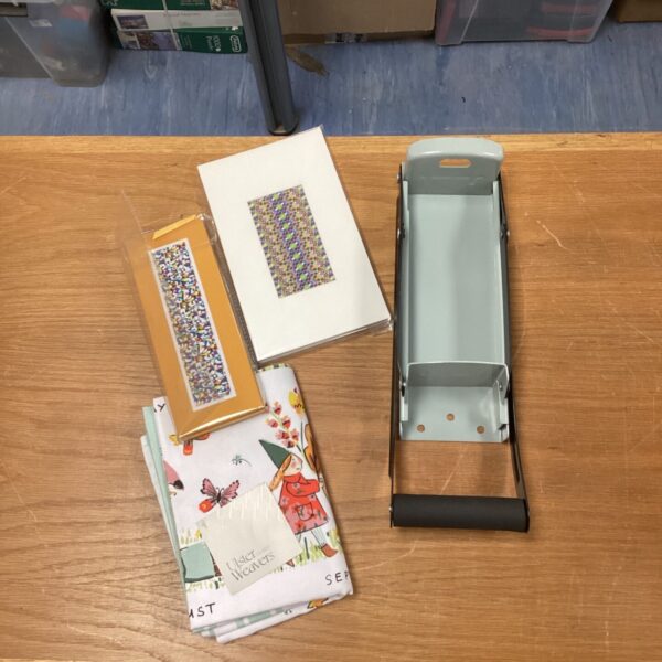 Mixed lot featuring a can crusher and notebooks for recycling and writing.