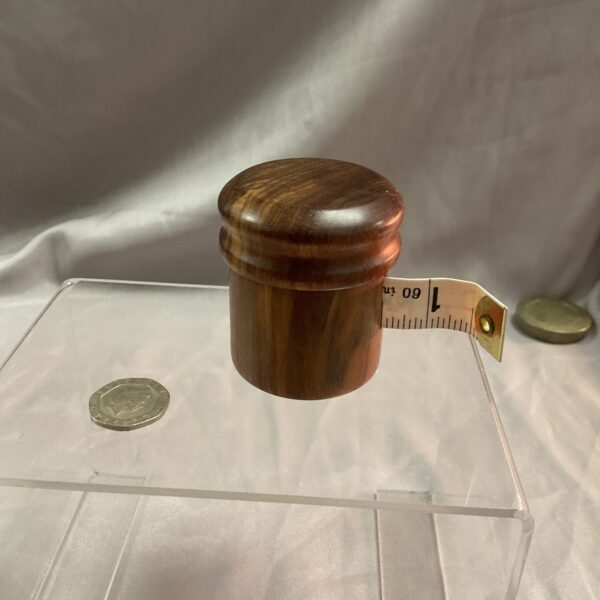Vintage turned wood tape measure with retractable tape.
