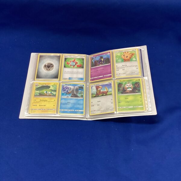 Front view of a Pokemon card file with trading cards inside.