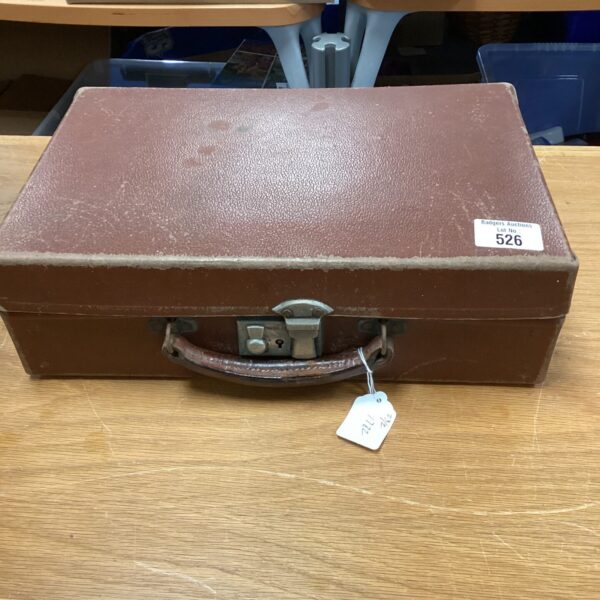 Front view of a vintage leather topped metal briefcase.