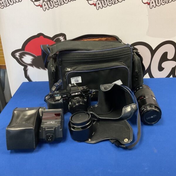 Vintage Minolta 7000 35mm camera kit with lenses and accessories.