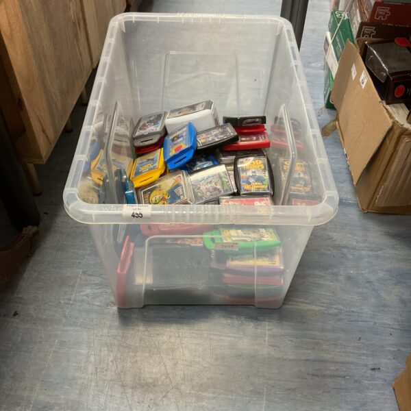 A plastic container filled with a large collection of Top Trumps cards.