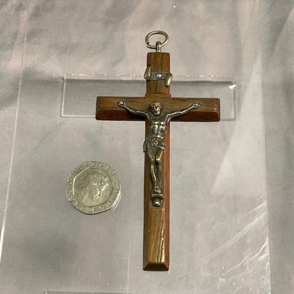Vintage wooden crucifix with figure of Christ on a cross.