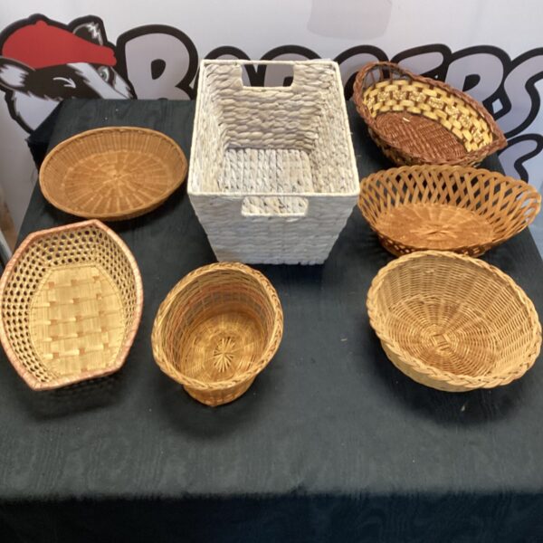Seven small wicker baskets displayed together, vintage style.