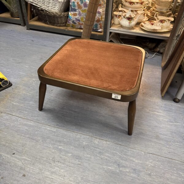 Vintage Ercol footstool with fabric top and wooden frame.