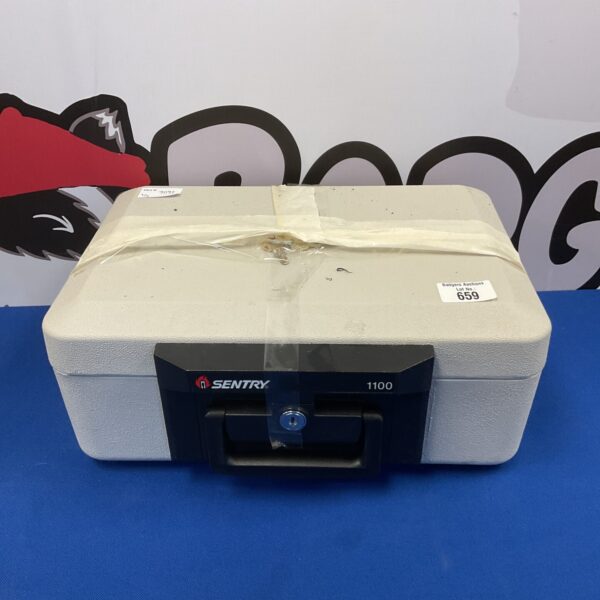 Vintage Sentry 1100 safe box with keys for secure storage.