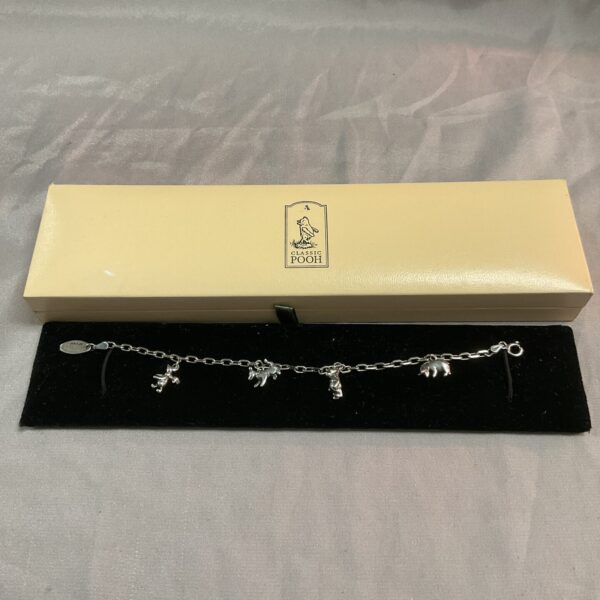 Silver Winnie the Pooh charm bracelet with detailed character charms.
