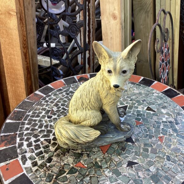 Detailed resin fox garden ornament for outdoor display.
