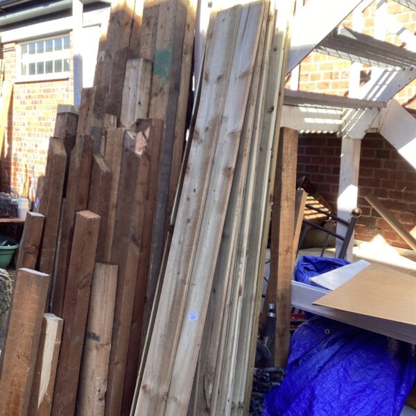 Stack of weathered wooden feather edging for garden fencing.