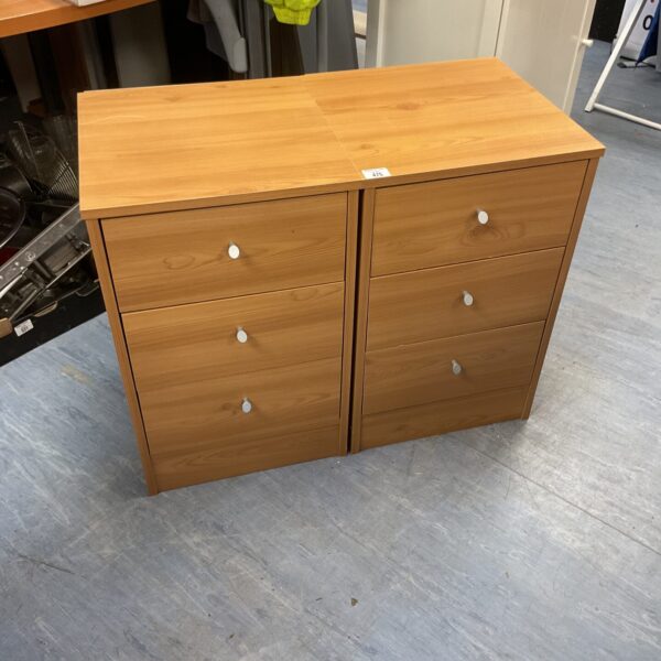 Two wooden three-drawer bedside cabinets for bedroom storage.