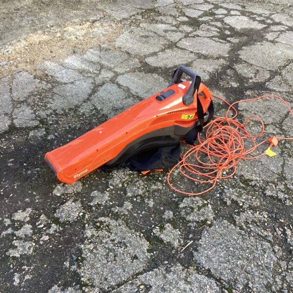 Side view of a used Flymo Garden Vac for garden cleaning.