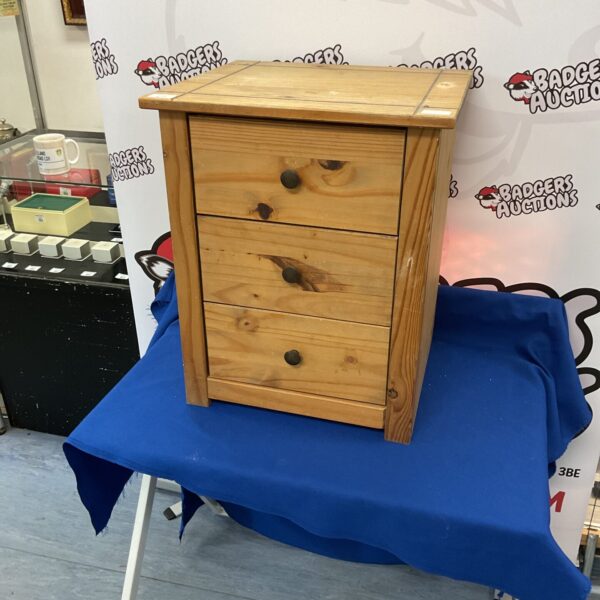 Small pine bedside cabinet with three drawers, vintage style.