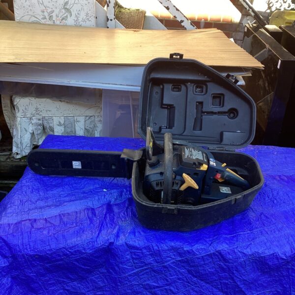 Performance chainsaw in its original carrying case, a vintage garden tool.