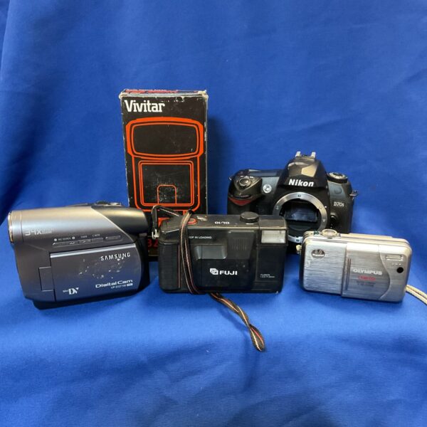 Vintage camera lot featuring Nikon and Samsung cameras.