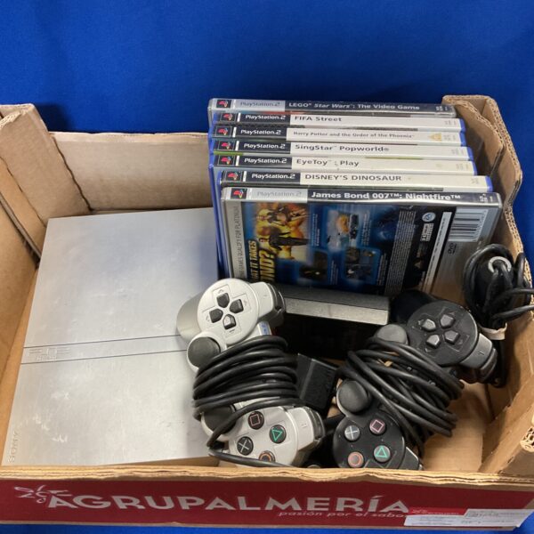 Silver Sony PlayStation 2 slim console with games included.