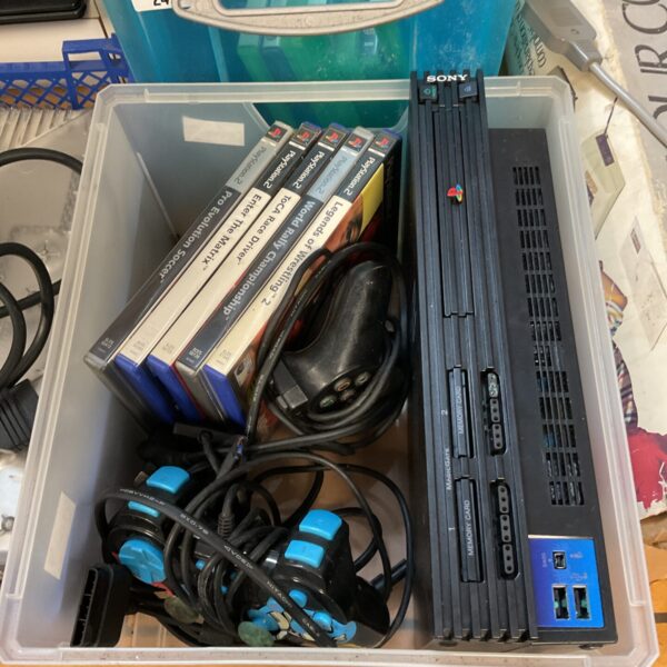 Sony PlayStation 2 console with controllers and games bundle for retro gaming.