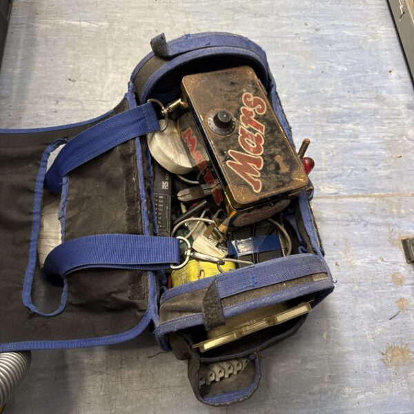 Vintage blue tool bag filled with various tools and components.