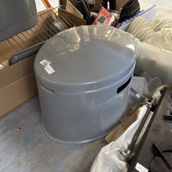 Grey portable camping toilet, outdoor sanitation solution.