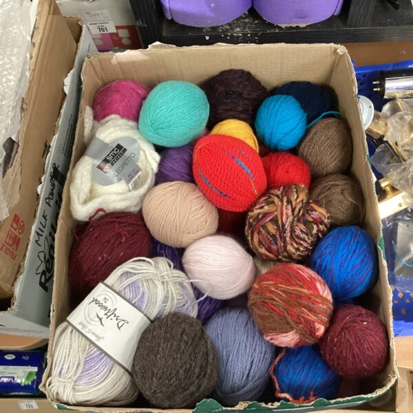Mixed lot of colourful balls of wool for knitting projects.