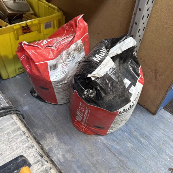 Two bags of grey Multicem cement powder for building and DIY.