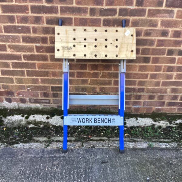 Front view of a vintage TUV work bench with metal legs.