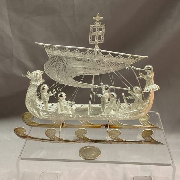 Detailed silver filigree dragon boat, a beautiful Asian collectible.