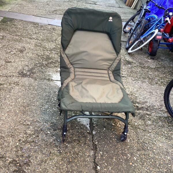JRC Cocoon recliner fishing chair in outdoor setting.