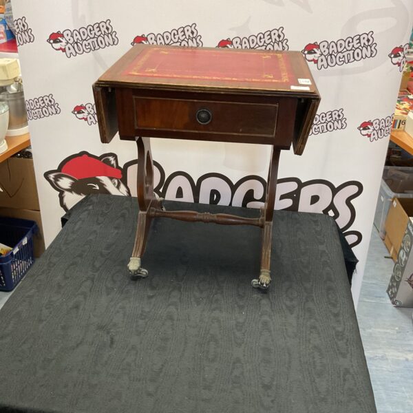 Elegant Georgian style magazine table with leather top and claw feet.