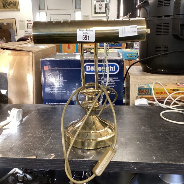Antique brass bankers lamp with adjustable shade and weighted base.