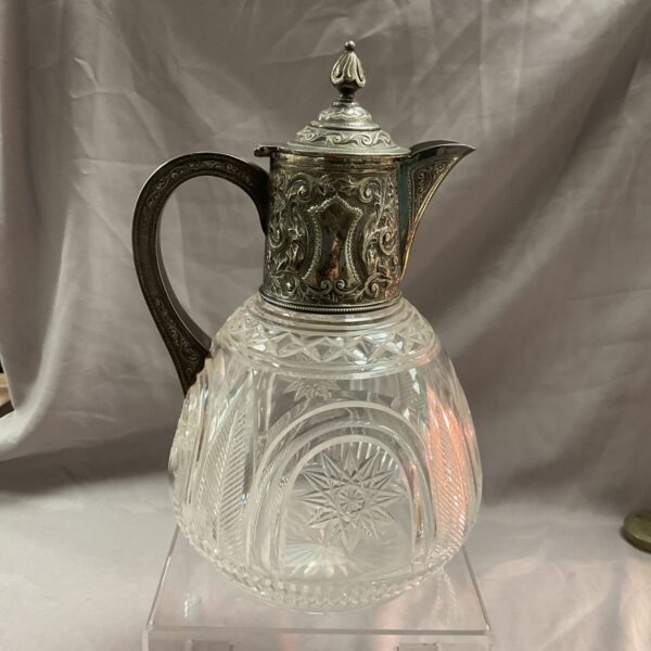 Antique silver topped claret jug with crystal body.