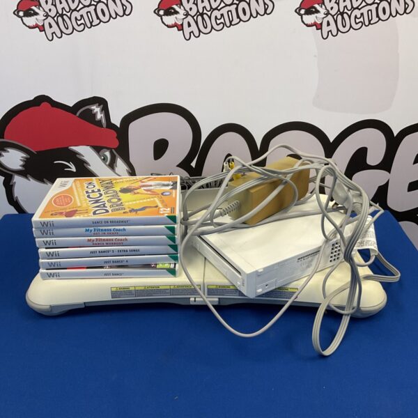 Nintendo Wii console with games and fitness board for retro gaming fun.