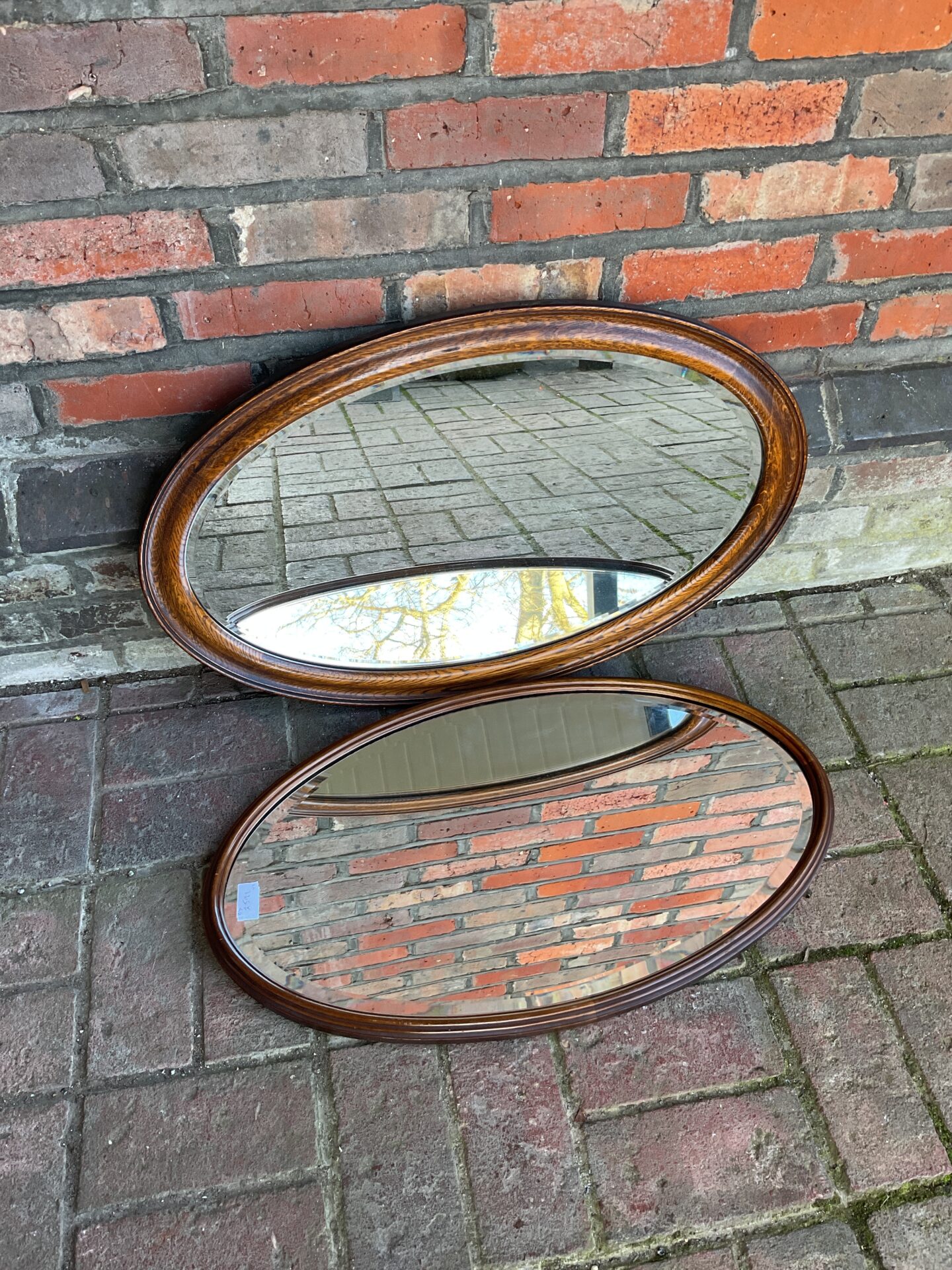 774 Two mid century oval oak framed mirrors