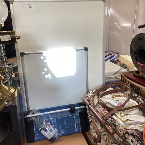 Whiteboard bundle with pens and paper guillotine for office use.