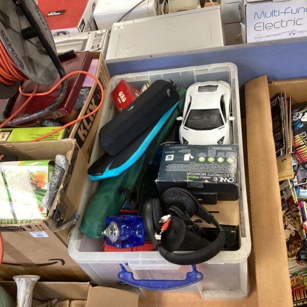 Mixed electronics lot with speakers and charger inside a box.
