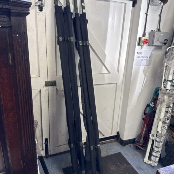 Two vintage military stretchers showing signs of wear.