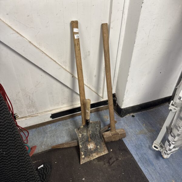 Vintage lot of garden tools including pickaxe and sledge hammer.