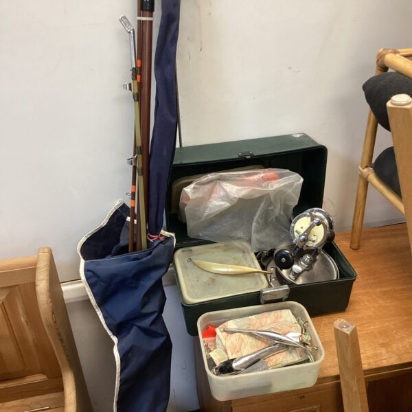 Vintage fishing gear lot including rods and tackle box.
