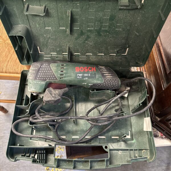 Bosch PMF 180E multi tool open showing internal components.