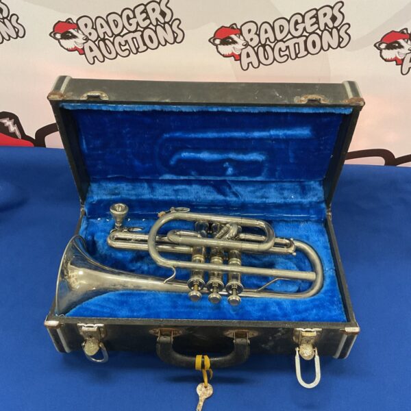 Vintage Cafact cornet in its original case, a collectible brass instrument.