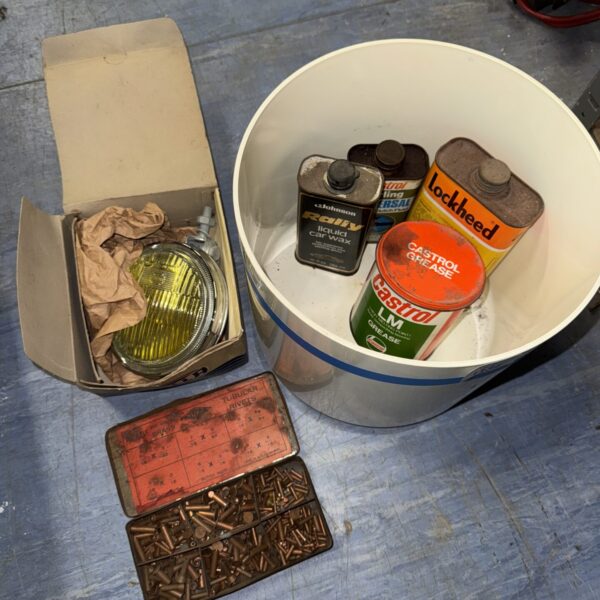Vintage car parts lot including grease, rivets and a Hella spot lamp.